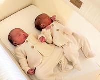 Twin newborn babies wearing cream onesies asleep in a Clair de Lune Organic Breathable Folding Crib in cream - Co-sleepers - Bedside Cribs