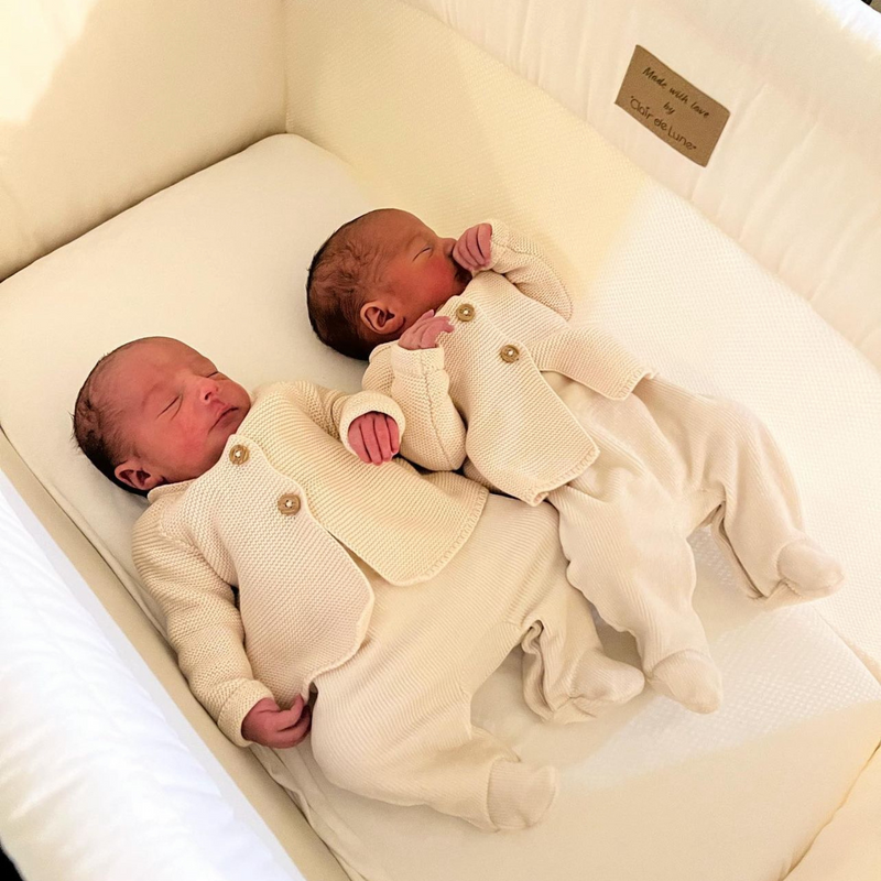 Twin newborn babies wearing cream onesies asleep in a Clair de Lune Organic Breathable Folding Crib in cream - Co-sleepers - Bedside Cribs