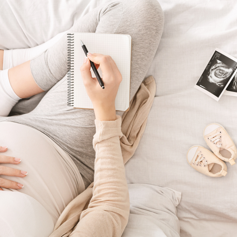 Pregnant mum wearing loungewear next to her scan photo and baby boots writing Black Friday wish list | Black Friday | Baby Essentials - Clair de Lune UK
