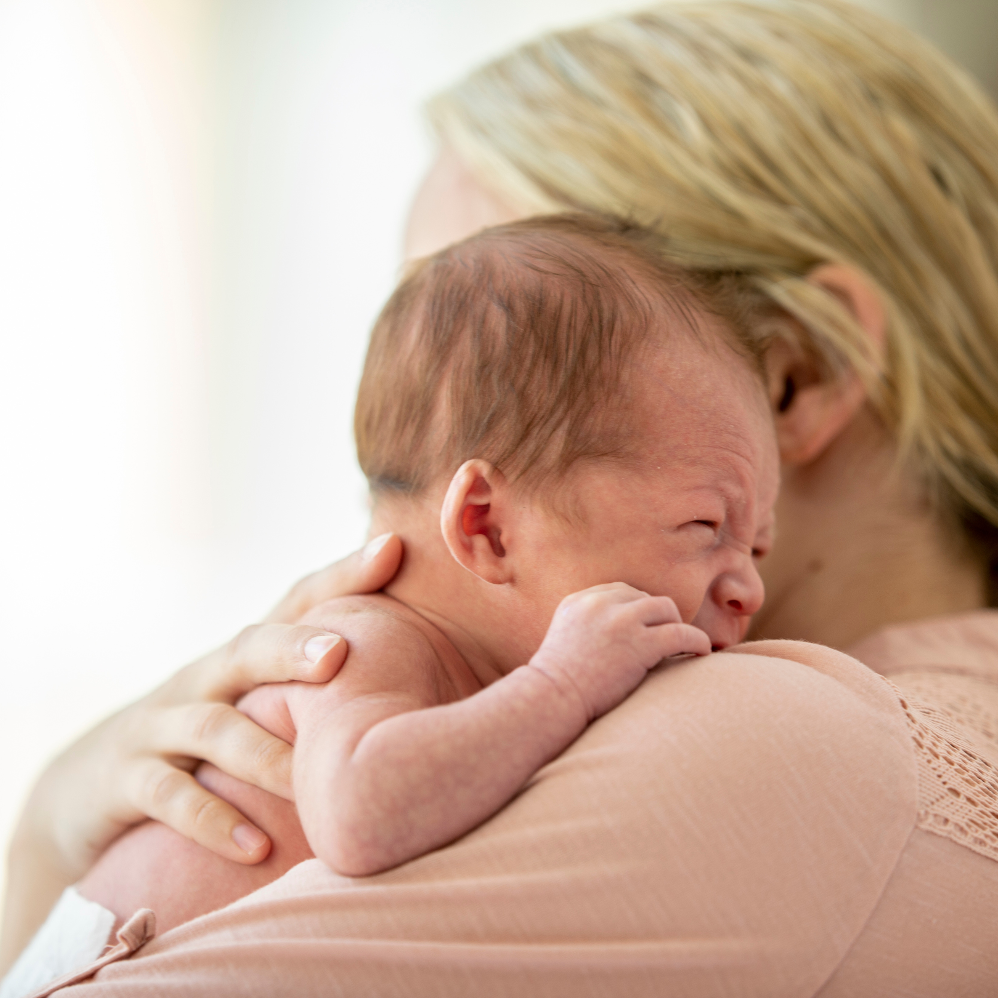 Newborn baby being burped over mum's shoulder | Parenting tips and advice | Colic Awareness - Clair de Lune UK