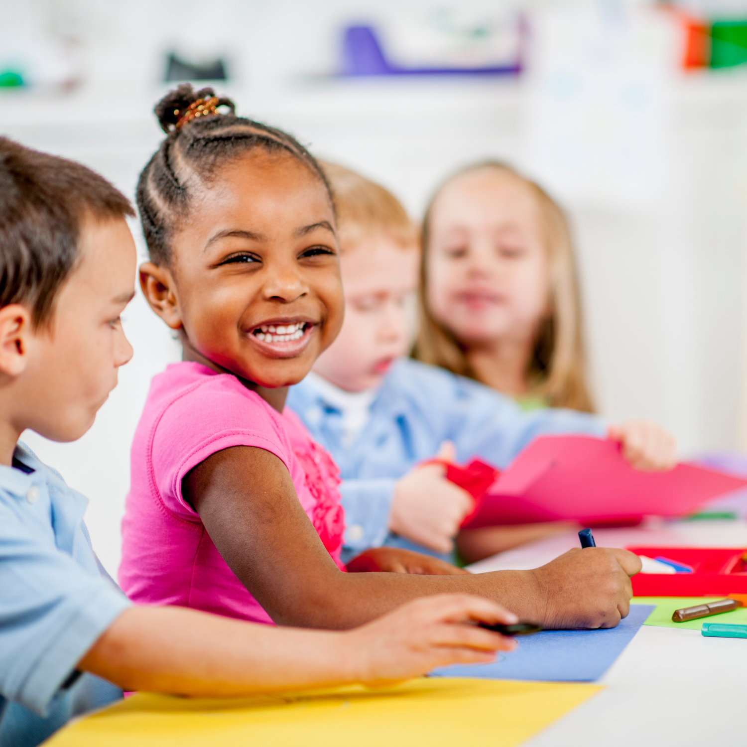 3 Children sitting at the dining table smiling and doing crafts | Parenting tips and advice - Clair de Lune UK