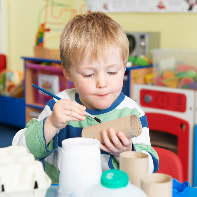 Preschooler painting a cardboard toilet roll crafting with recyclable materials | Family Time | Recycled Children's Crafts - Clair de Lune UK