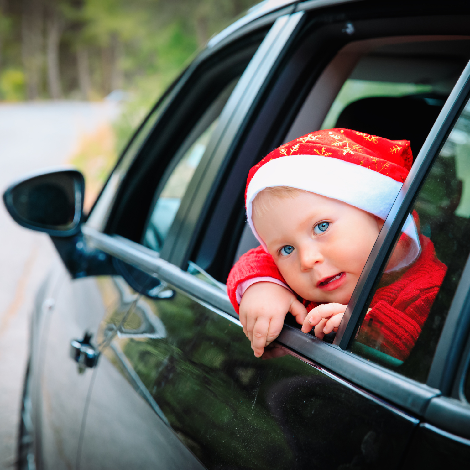 Little boy wearing a santa hat waving through the car window | Family Christmas - Clair de Lune UK