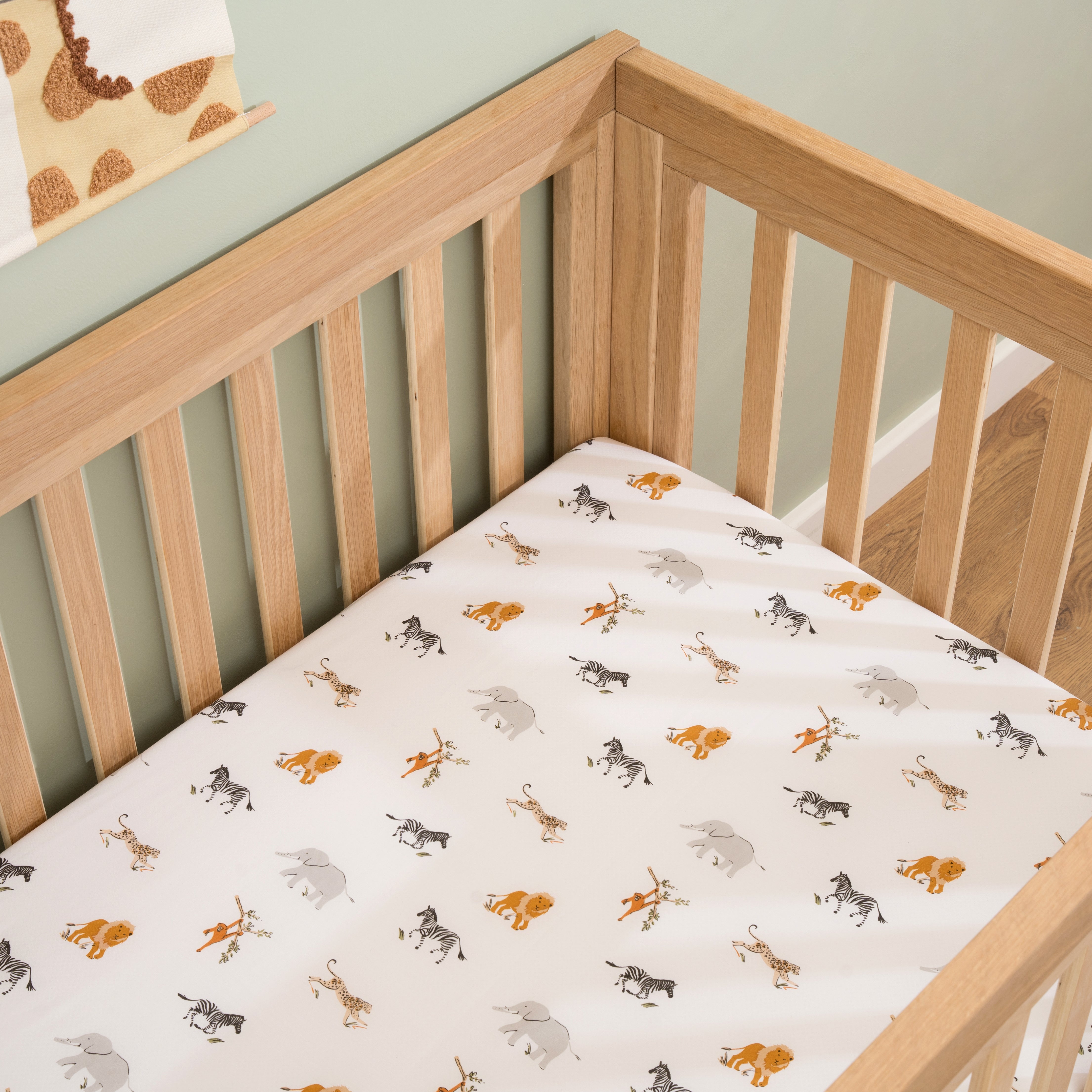 Organic Reversible Cot Bedding in Sage on the White Essentials Cot Bed in a neutral green nursery | Baby Essentials | Buying Guides - Clair de Lune UK