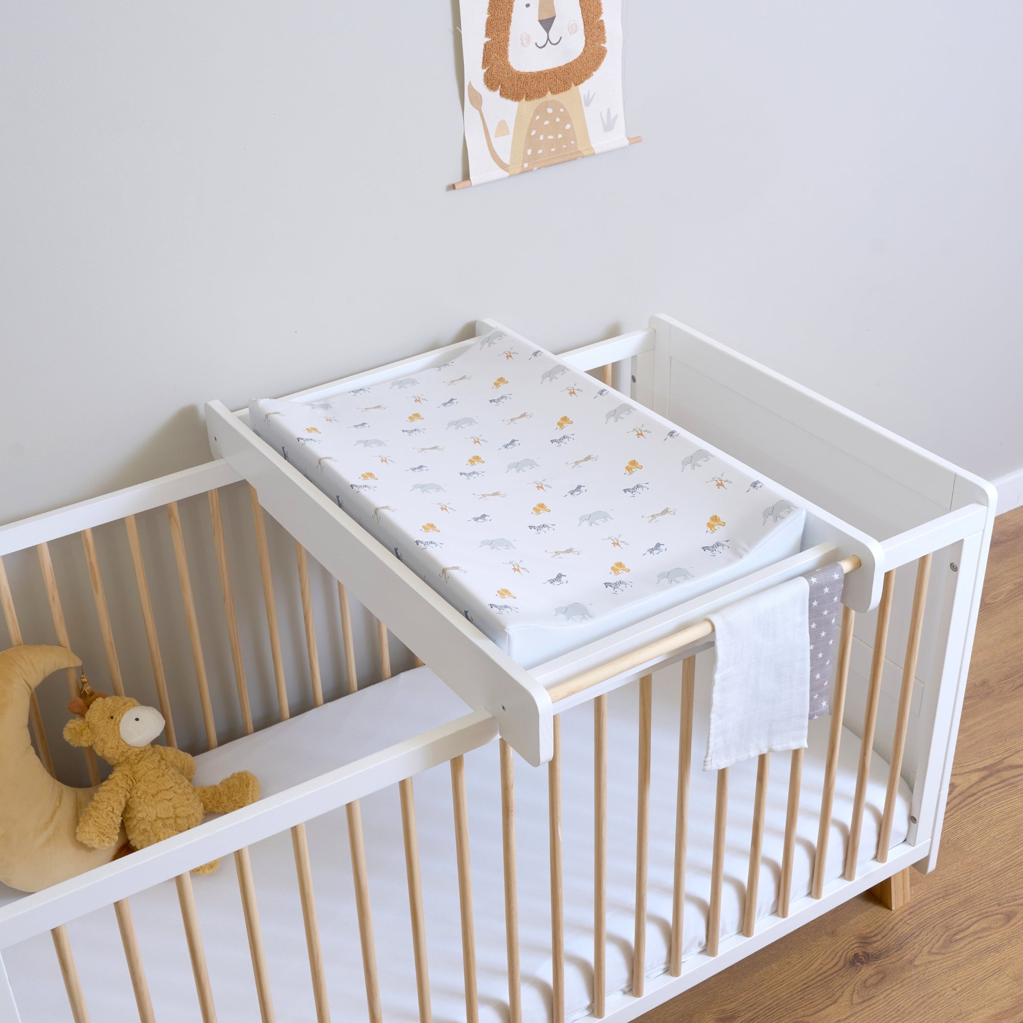 The Jungle Dream Foldable Changing mat on the Essentials Cot Top Changer & Cot Bed in a neutral nursery | Black Friday Offers - Clair de Lune UK