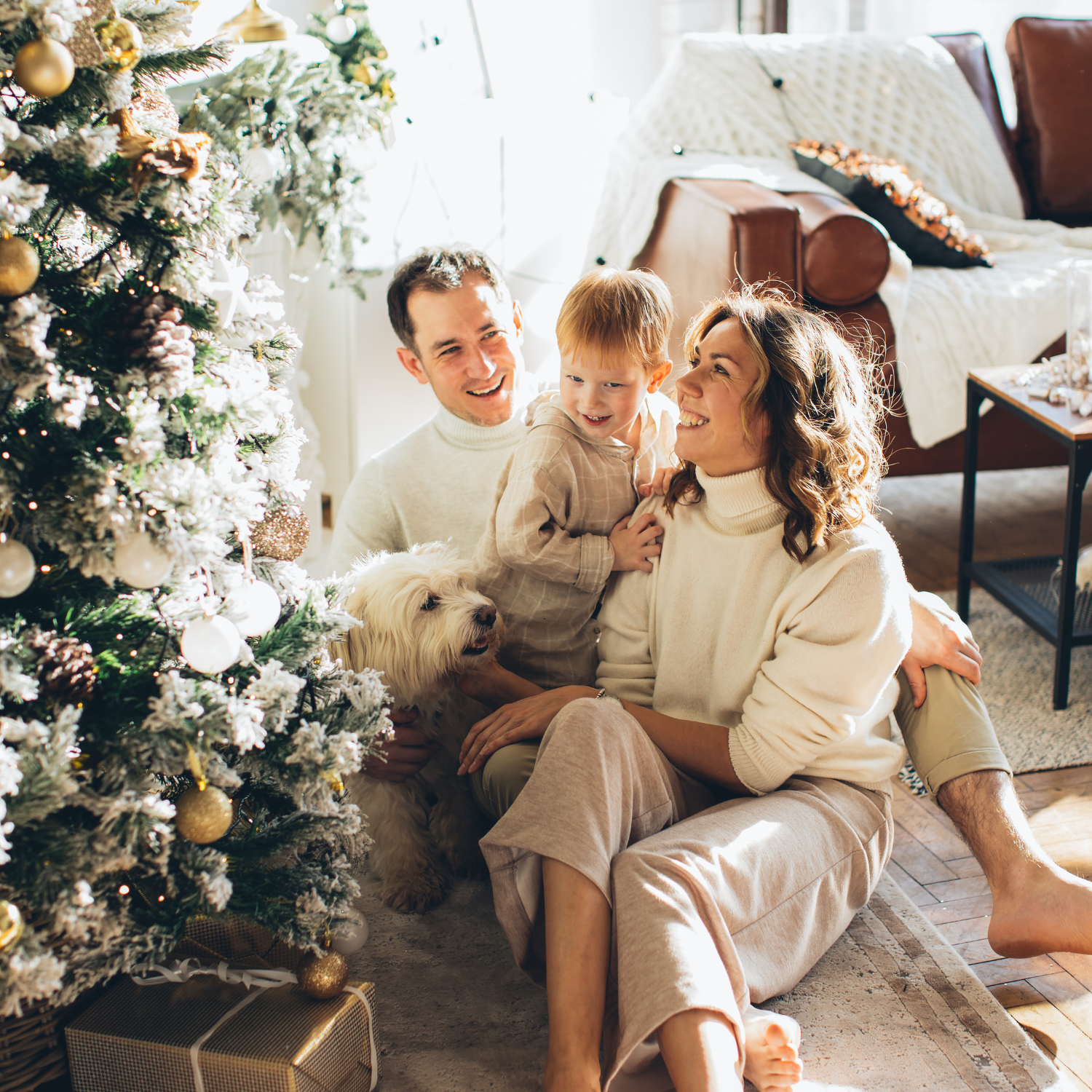 Family with newborn enjoying a family Christmas in front of the tree - Clair de Lune UK