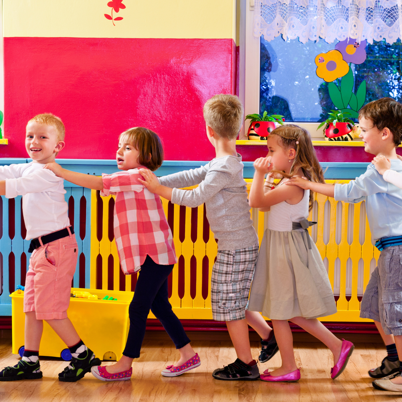 School children in a line holding hands in the school hall | Back to school - Clair de Lune UK