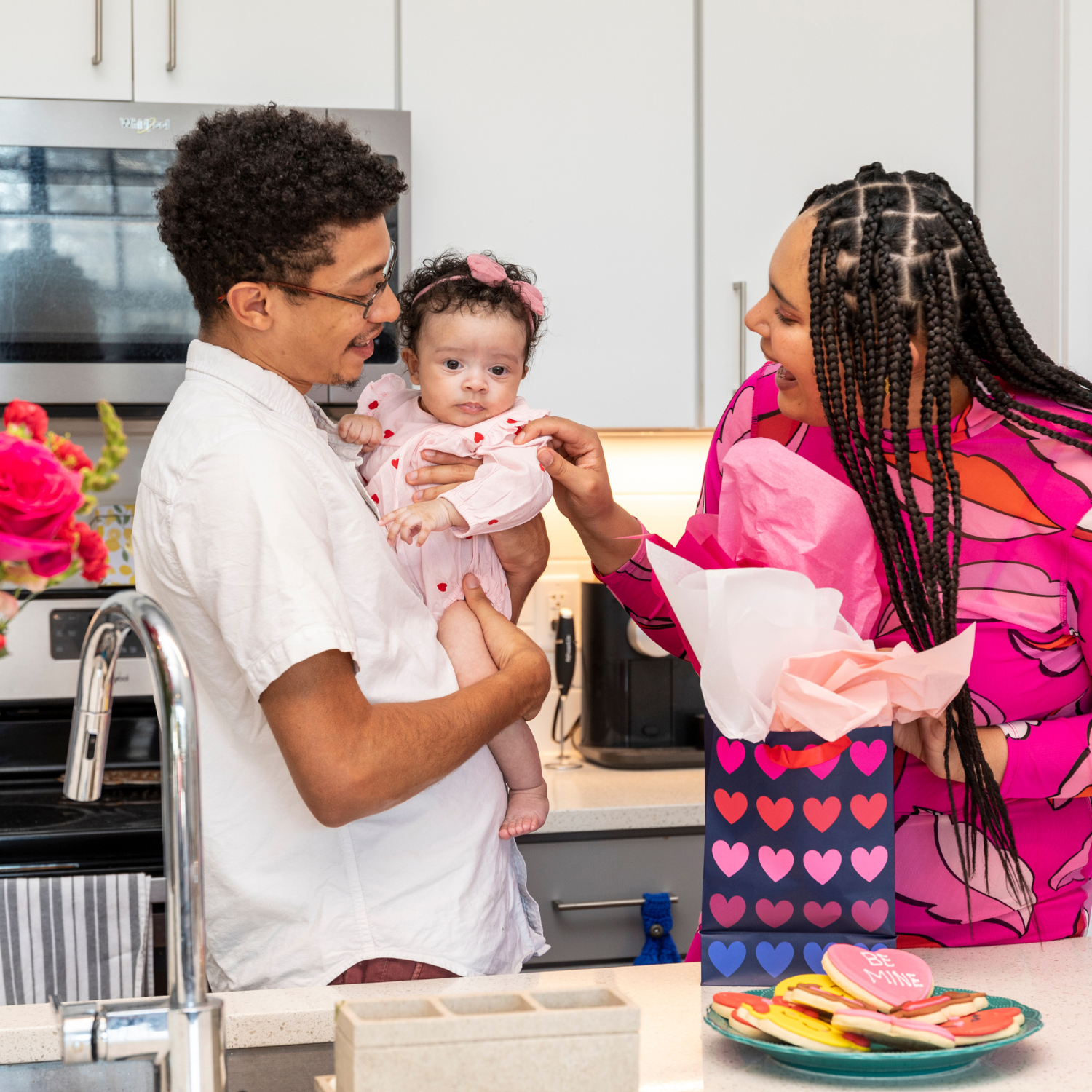 Mum, Dad and Baby Celebrating Valentines Day with Gifts and Homemade love heart biscuits | Valentines Day | Family Time - Clair de Lune UK