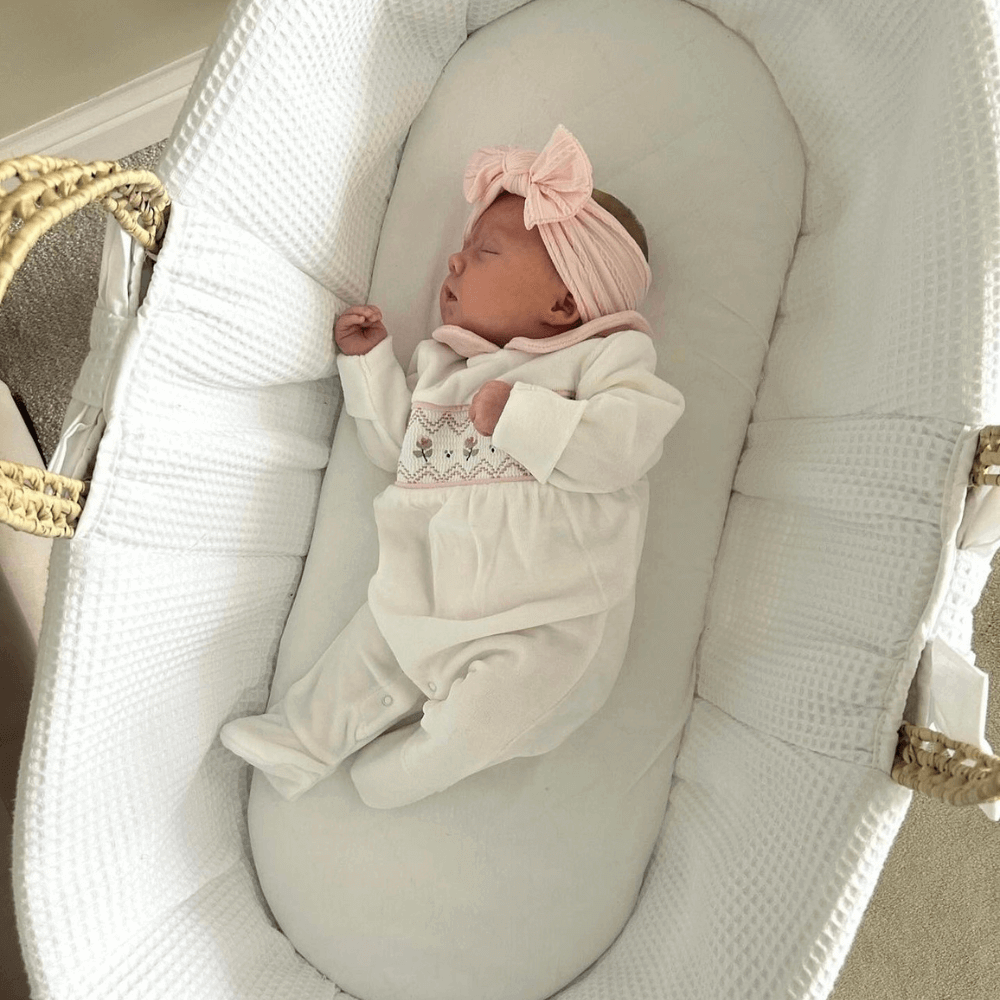 Baby Sleeping Soundly for a Nap in the White Chelsea Palm Moses Basket | Top Tips for Your Baby's Sleep by Age | Nursery Furniture - Clair de Lune UK