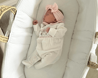 Baby Sleeping Soundly for a Nap in the White Chelsea Palm Moses Basket | Top Tips for Your Baby's Sleep by Age | Nursery Furniture - Clair de Lune UK
