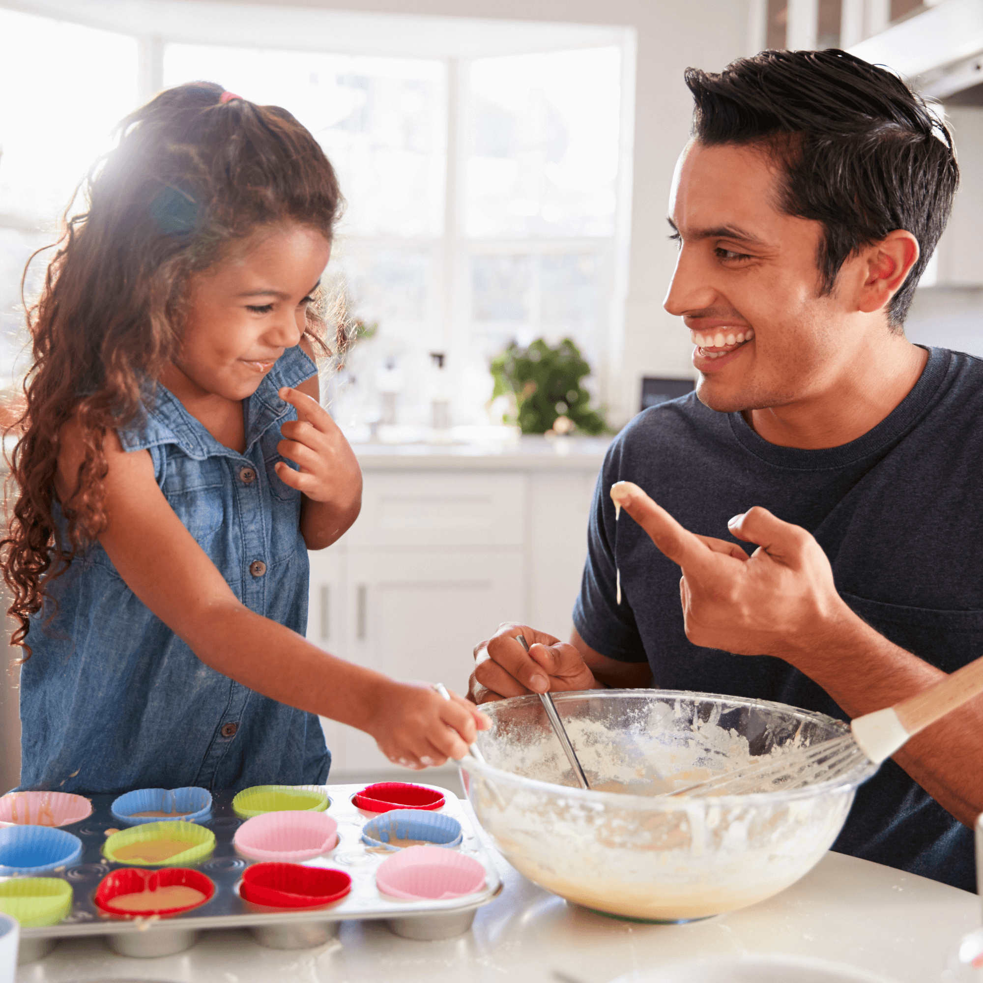 Dad and daughter laughing at each other while baking cakes in the kitchen | Family Time | Father's Day - Clair de Lune UK