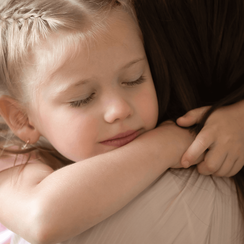 Blonde toddler girl hugging her mum | Family New Year - Clair de Lune UK