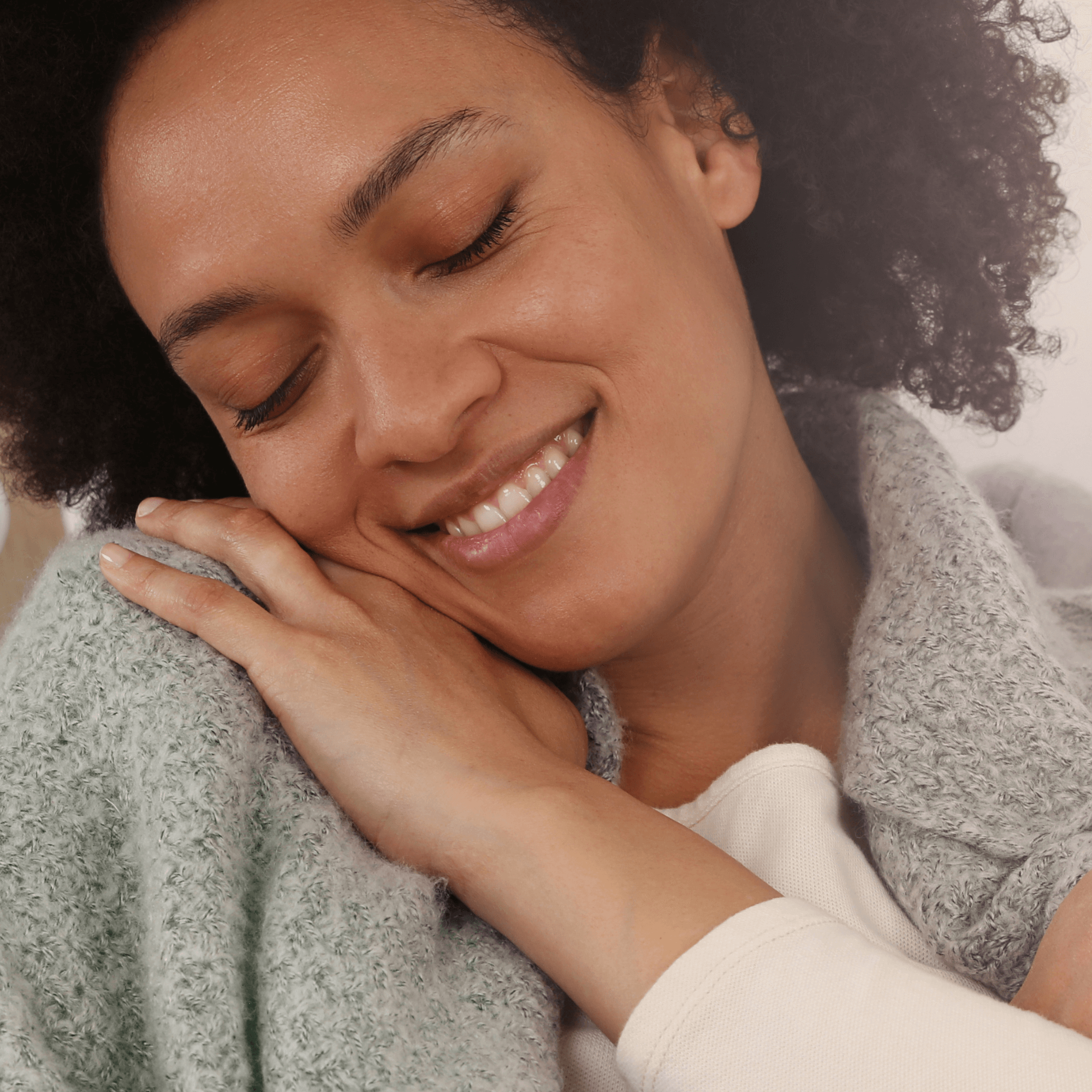 Mum resting her head on her shoulder smiling with her eyes closes | Post partum tips and advice - Clair de Lune UK