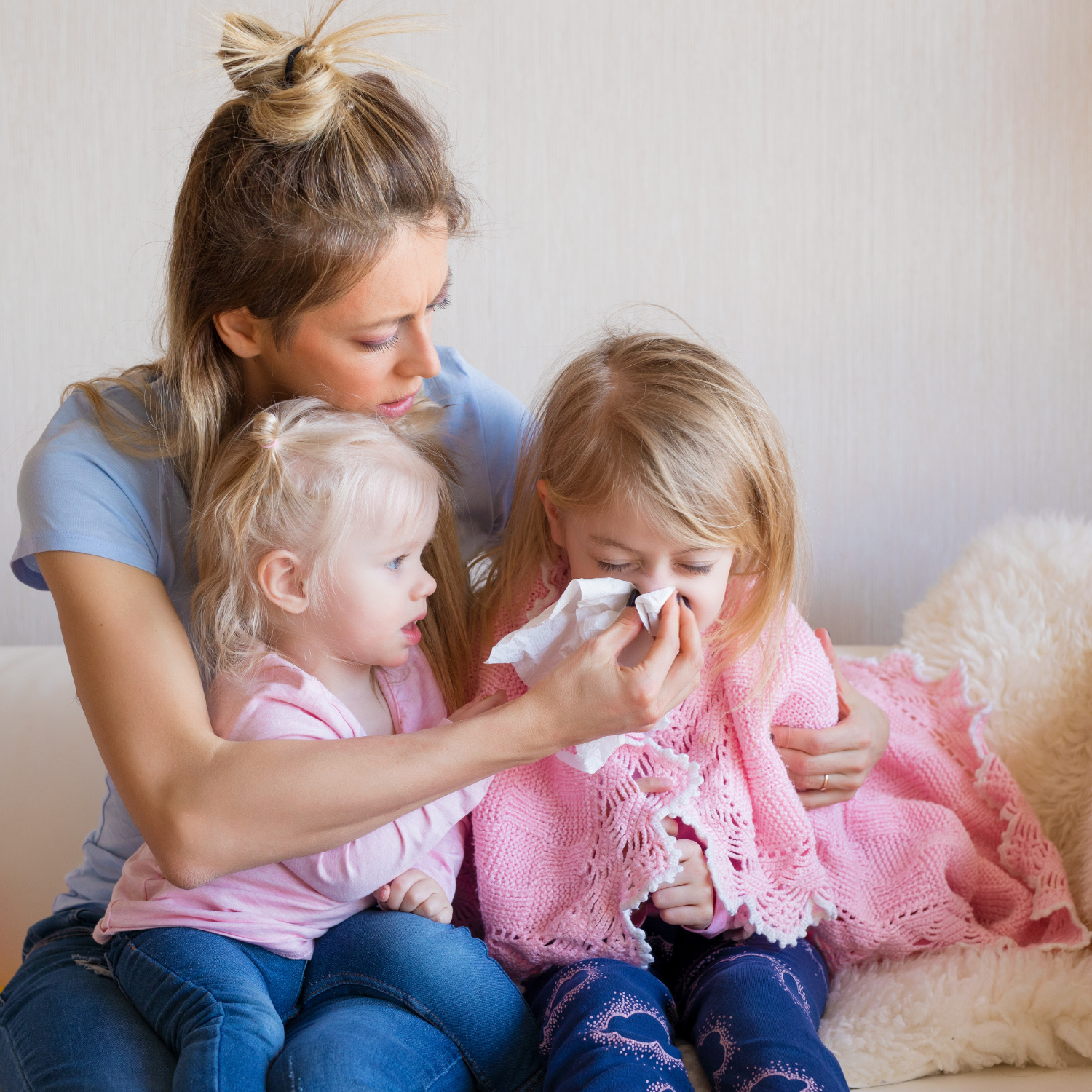 Mum sat wiping the noses of her two children | Family Health - Clair de Lune UK