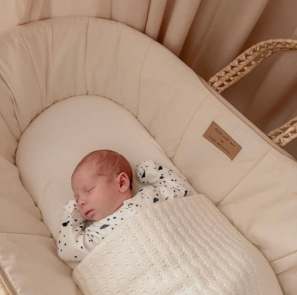 Newborn baby asleep in a cream Organic Cotton Moses Baskets | Bassinets and Co Sleepers | Parenting tips and advice - Clair de Lune UK