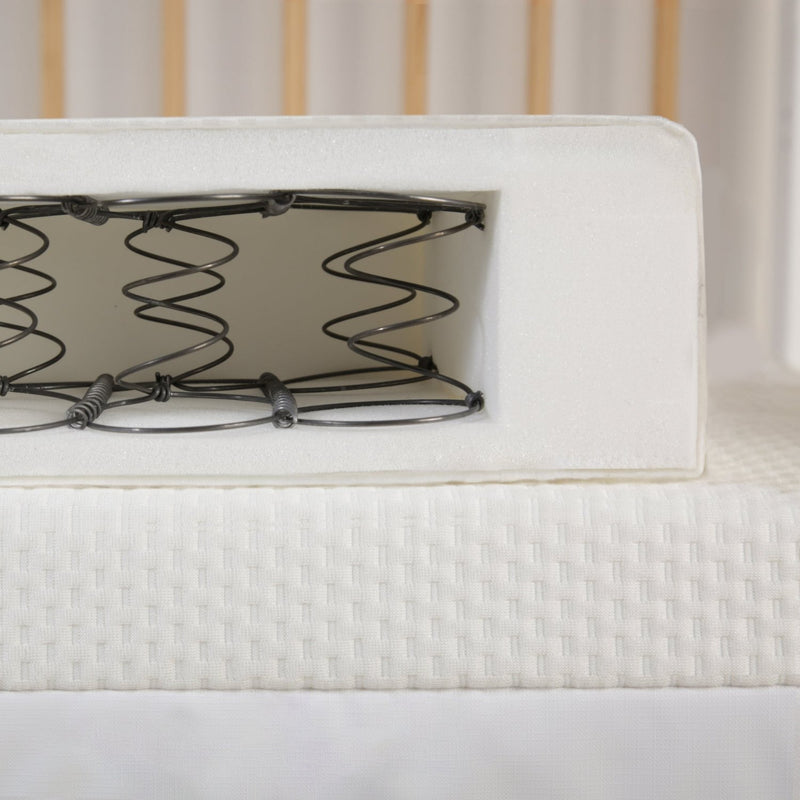 Cuddleco Harmony Cot Mattress in Cot with Cross-Section showing the Coils - Clair de Lune UK