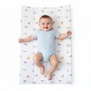 Smiling baby lying on the Jungle Dream Anti-Roll Wedge Baby Changing Mat |  Change & Travel Mats | Baby Bath Time Essentials - Clair de Lune UK