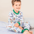 Boy sat smiling wearing the Grow Grows Organic Safari Slumber Pyjamas | Organic Kids PJs and Nightwear - Clair de Lune UK