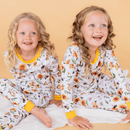Two girls laughing wearing the Grow Grows Organic Honey Bees Pyjamas | Organic Kids PJs and Nightwear - Clair de Lune UK