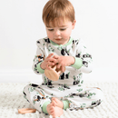 Toddler playing with a wooden toy wearing the Grow Grows Organic Playful Pandas Pyjamas | Organic Kids PJs and Nightwear - Clair de Lune UK