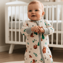 Baby wearing the GrowGrows Organic Cozy Cubs Sleepsuit in the nursery | Baby Grows and Onesies | Organic Baby Clothes - Clair de Lune UK