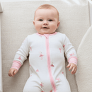 Baby wearing the pink Grow Grows Organic Tiny Twirls Sleepsuit | Baby Grows and Onesies | Organic Baby Clothes - Clair de Lune UK