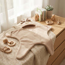 Oatmeal brown star fleece baby wrap blanket draped over a changing table in the nursery | Baby Blankets and Swaddles - Clair de Lune UK