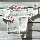 Grow Grows Organic Tiny Twirls Pyjamas folded on wooden floor | Organic Kids PJs and Nightwear - Clair de Lune UK