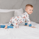 Toddler crawling on the bed wearing the GrowGrows Organic Seaside Sailor Sleepsuit | Baby Grows and Onesies | Organic Baby Clothes - Clair de Lune UK