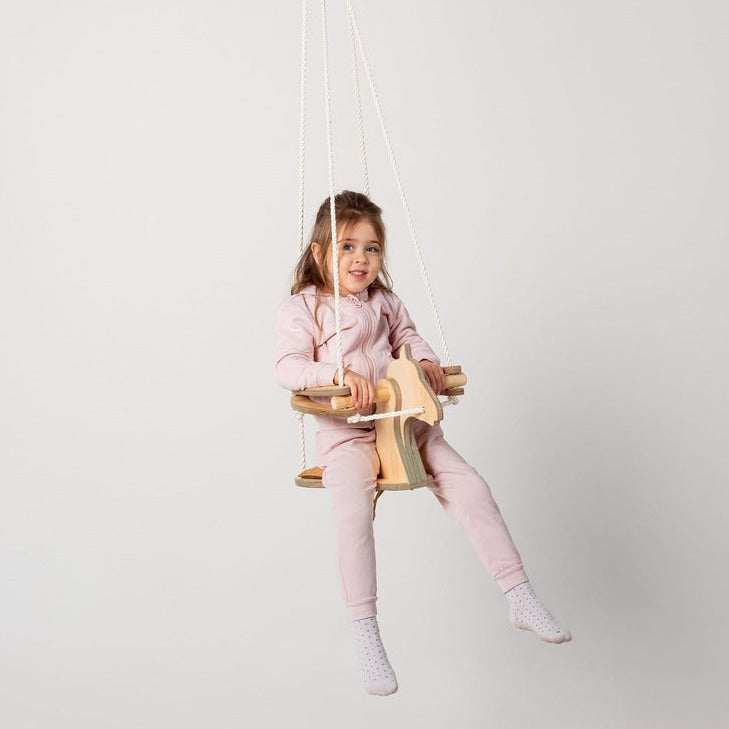 Little girl having fun riding the Goodevas Montessori Horse Rope Swing | Montessori Activities For Babies & Kids - Clair de Lune UK