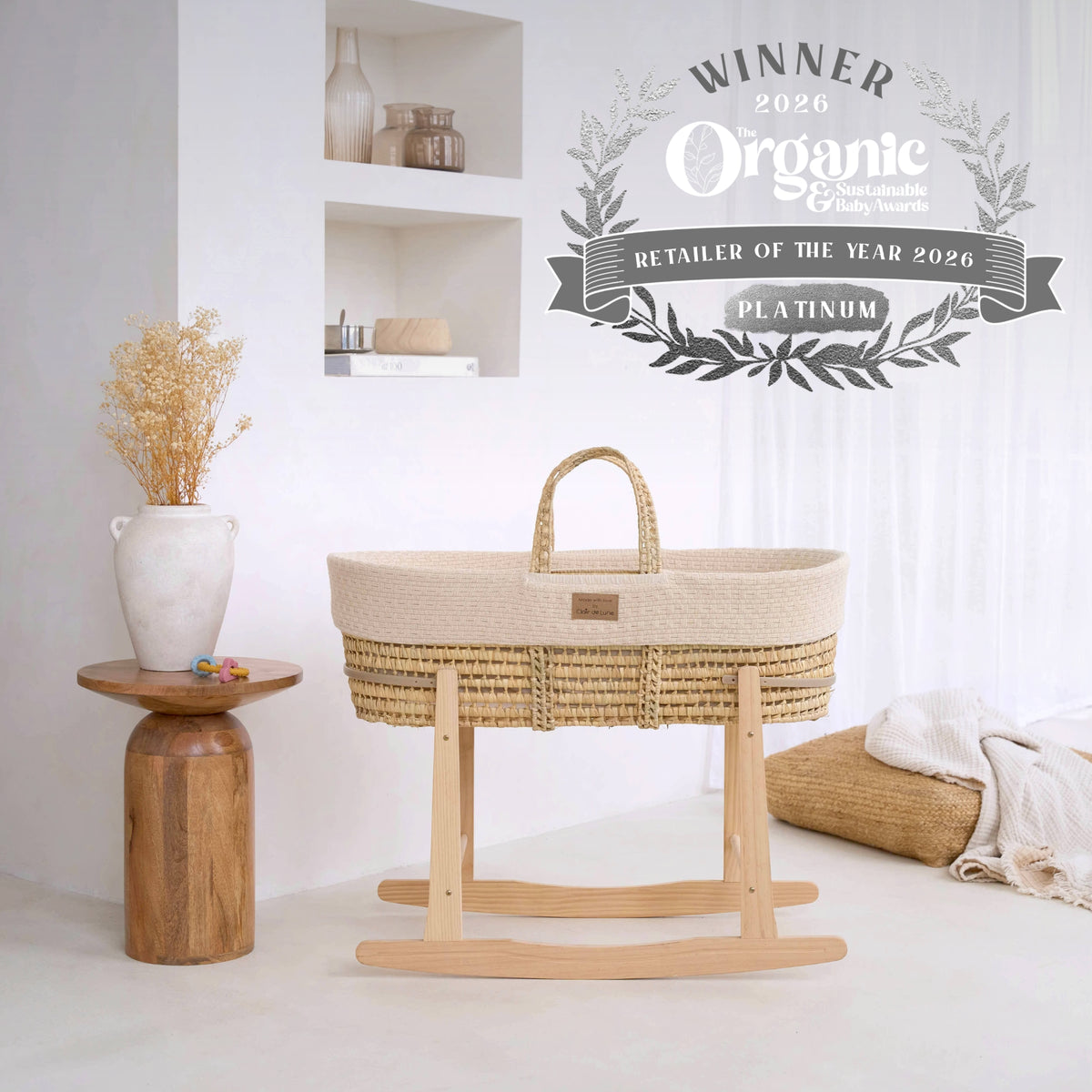 Organic Knitted Palm Moses Basket showcasing the Platinum Award for Retailer of the Year in the 2026 Organic & Sustainable Baby Awards