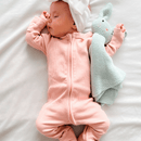 Newborn wearing the Blush Grow Grows Organic Ribbed Baby Sleepsuit with the Bunny Grow Grows Organic Comforter | Baby Sleep Wear | Children's pyjamas - Clair de Lune UK