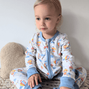 Toddler sat up wearing the GrowGrows Organic Up, Up & Away Sleepsuit | Baby Grows and Onesies | Organic Baby Clothes - Clair de Lune UK