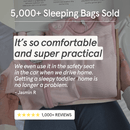 A person holding a box containing a  Pink pinstripe bamboo Smart baby sleeping bag 2.5 tog from GrowGrows, with promotional text overlays reading '5,000+ Sleeping Bags Sold' and customer review copy. The scene includes hands, clothing, and part of a bed or chair in a real indoor setting.