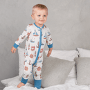 Boy jumping on the bed wearing the GrowGrows Organic Seaside Sailor Sleepsuit | Baby Grows and Onesies | Organic Baby Clothes - Clair de Lune UK