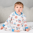 Boy sat up in bed wearing the Grow Grows Organic Seaside Sailor Pyjamas | Organic Kids PJs and Nightwear - Clair de Lune UK