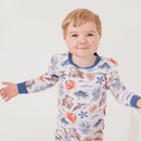 Boy standing and smiling at the camera wearing the Grow Grows Organic Sea Life Pyjamas | Organic Kids PJs and Nightwear - Clair de Lune UK