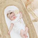 Baby girl playing in the Palm Moses Basket Undressed | Moses Baskets | Co-sleepers | Nursery Furniture - Clair de Lune UK