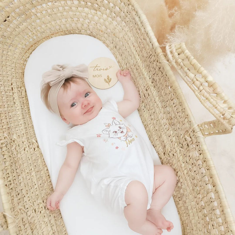 Baby girl playing in the Palm Moses Basket Undressed | Moses Baskets | Co-sleepers | Nursery Furniture - Clair de Lune UK
