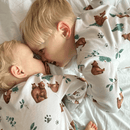 Toddler and baby cuddling up wearing the GrowGrows Organic Cozy Cubs Pyjamas | Organic Kids PJs and Nightwear - Clair de Lune UK