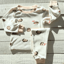 GrowGrows Organic Happy Hedgehogs Pyjamas folded on a grey wood background | Organic Kids PJs and Nightwear - Clair de Lune UK
