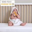 Baby wearing the Basic Hooded Towels in Biscuit with the Oeko-Tex logo | Baby Bathing & Changing Essentials - Clair de Lune UK