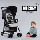Toddler sitting next to his Mickey Stars Hauck Disney Sport Pushchair | Prams, Pushchairs & Travel Systems | Baby Travel Essentials - Clair de Lune UK