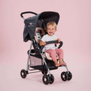 Toddler sitting on her pink Minnie Sweetheart Hauck Disney Sport Pushchair | Prams, Pushchairs & Travel Systems | Baby Travel Essentials - Clair de Lune UK