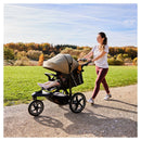 Mum out for a jog in the park with her baby in the Olive Hauck Runner 3 Pushchair | Prams & Strollers | Baby Travel Essentials - Clair de Lune UK