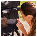 Mum looking at her toddler through the mesh ventilation panel on the Olive Hauck Runner 3 Pushchair in the park | Prams & Strollers | Baby Travel Essentials - Clair de Lune UK