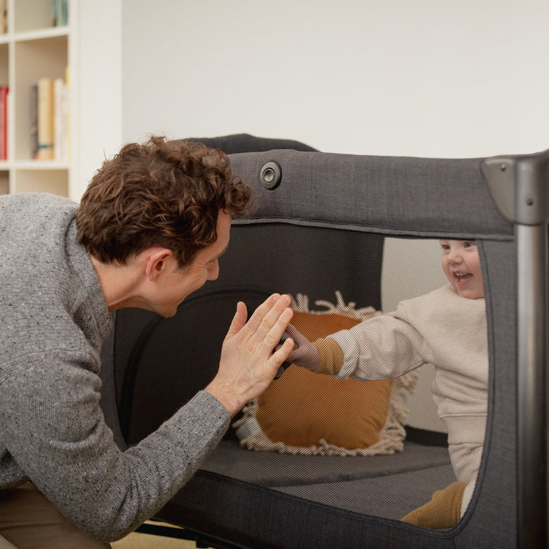 Dad playing his son staying in the Hauck Play N Relax Centre 4in1 Premium Travel Cot | Travel Cots & Travel Bassinets | Cots, Cot Beds, Toddler & Kid Beds | Nursery Furniture - Clair de Lune UK
