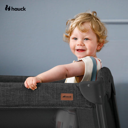 Toddler is having fun in his Hauck Play N Relax Centre 4in1 Premium Travel Cot | Travel Cots & Travel Bassinets | Cots, Cot Beds, Toddler & Kid Beds | Nursery Furniture - Clair de Lune UK