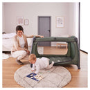 Baby boy crawling out of the Newborn lying in the Dark Green Hauck Play N Relax Center with the mesh zipped off | Travel Cots & Folding Cribs - Clair de Lune UK