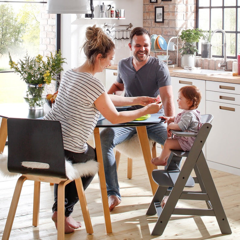 Mum and dad feeding toddler sitting on the Hauck Alpha+ Wooden Highchair with Removable Front Bar in Grey | Highchairs | Feeding & Weaning - Clair de Lune UK